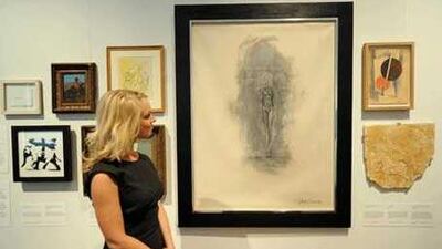 Riah Prior, a researcher, views fake artwork at a London exhibition of forgeries.