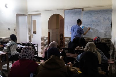 Ihab Abdelwahab, director of the Sudanese School of Dreams for Elementary, Intermediate, and Secondary Education, teaches students in Cairo. Reuters