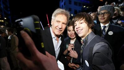 Actor Harrison Ford poses for a fan as he arrives at the premiere of Star Wars: The Force Awakens in Hollywood, California. Mario Anzuoni / Reuters