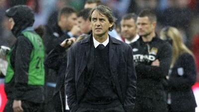 Roberto Mancini regrets not being able to sign Robin van Persie at the start of the season. Ian Kington / AFP