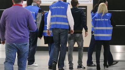 Airport staff walk to a non-public area where people waiting for the Germanwings flight from Barcelona have been taken. Frank Augstein/AP Photo