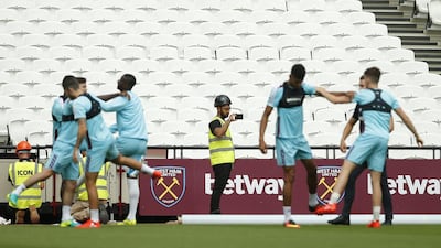 Workmen watch on during training at Queen Elizabeth Olympic Park on August 3, 2016 in London, England. Reuters / Andrew Couldridge