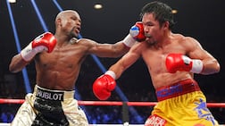 FILE PHOTO: Floyd Mayweather, Jr. of the U. S. lands a left to the face of Manny Pacquiao of the Philippines (R) in the 11th round during their welterweight WBO, WBC and WBA (Super) title fight in Las Vegas, Nevada, May 2, 2015. REUTERS / Steve Marcus / File Photo
