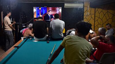 Beirut residents watch a televised interview with Saad Hariri. International donors say a government must be established before they can help Lebanon.