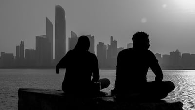 People take in the views at the corniche in Abu Dhabi during the holiday to mark the anniversary of Prophet Mohammed's birth. Victor Besa / The National