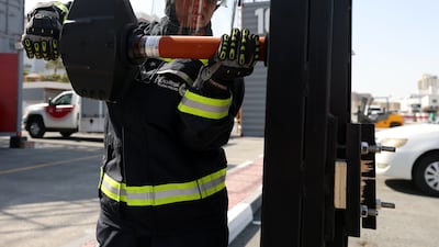 Latifa Al Maqbali breaks through a door as part of her training