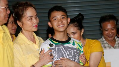 Duangphet Phromthep with family members after he and his teammates were rescued from caves in 2018. AP