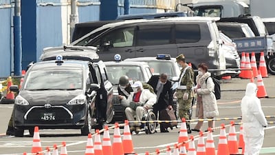 Passenger take a taxi after after disembarking from the Diamond Princess cruise ship - in quarantine due to fears of the new COVID-19 coronavirus - at the Daikoku Pier Cruise Terminal in Yokohama. AFP