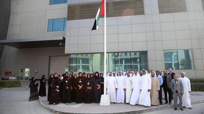 HE Ahmad bin Shafar, CEO of Empower, hoists the UAE flag at the Dubai International Financial Centre (DIFC) plant. Courtesy Empower