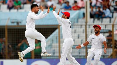 Afghanistan spinner Rashid Khan, left, finished with 11 wickets in Chittagong as Bangladesh were beaten by 224 runs. AFP