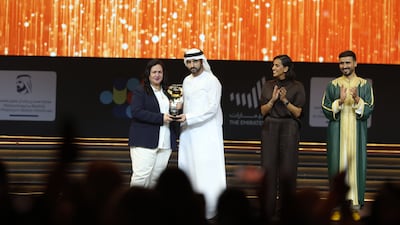 Sheikh Hamdan bin Mohammed, Crown Prince of Dubai, Deputy Prime Minister and Minister of Defence, crowns Fouzia Mahmoudi as Arab Hope Maker of the Year at a ceremony at Coca-Cola Arena. Also pictured are joint winners Hind Al Hajri and Abdul Rahman Al-Rais. All photos: Chris Whiteoak / The National