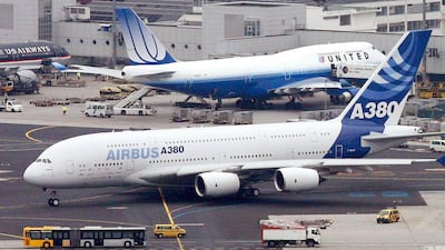 An Airbus A380 rolls past a Boeing 747 of United Airline in Frankfurt. Small planes are taking over the old four-engine jumbos. Boris Roessler / EPA