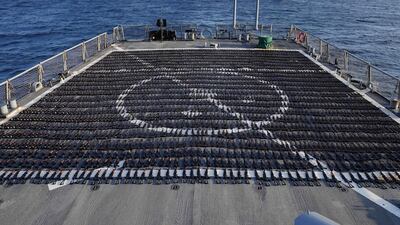 The confiscated rifles laid out on the deck of the destroyer