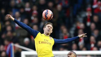 Arsenal's Nacho Monreal is challenged by Brighton's Chris O'Grady during their FA Cup match on Sunday. Stefan Wermuth / Reuters