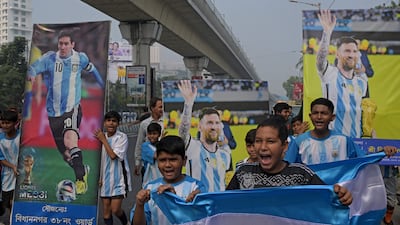 Young fans carry posters of Inter Miami's Argentine forward #10 Lionel Messi, on the eve of his visit, in Kolkata. AFP
