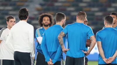 Marcelo of Real Madrid listens to his manager during training.