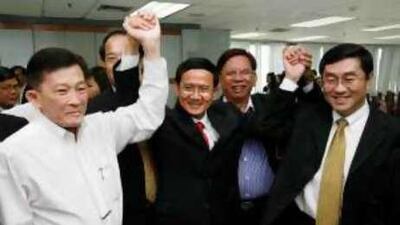 Somchai Wongsawat, centre, celebrates with Sompong Amornwiwat, left, the justice minister, and Surapong Suebwonglee, the finance minister, after Mr Somchai was nominated yesterday for the office of prime minister.