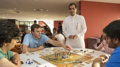Members of Tabletop Café, a community of board-game enthusiasts, play a game during one of the group’s twice-weekly meetups at Gloria Hotel in Dubai Internet City. Antonie Robertson / The National
