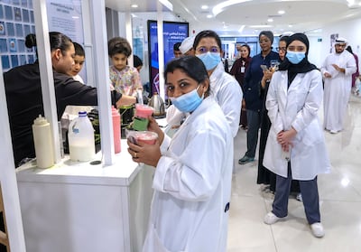 Hospital doctors, nurses and staff can't get enough macha goodies at Mahra's stand. Victor Besa / The National