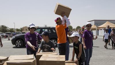 Volunteers collect the water that they will distribute to workers as part of the Sameness Project's water distribution campaign to workers during the hot summer months. Antonie Robertson / The National