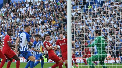 Brighton defender Lewis Dunk scores the equaliser against Liverpool on Sunday. AFP