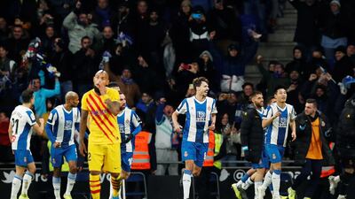 Espanyol's Wu Lei celebrates scoring their second goal with teammates as Barcelona's Jordi Alba and Luis Suarez look dejected. Reuters