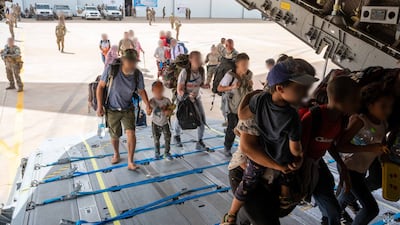 Foreign citizens board a plane at a French military air base in Khartoum to leave Sudan on April 23. AFP