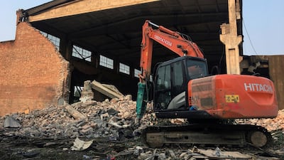 An excavator is seen on the debris in front of the demolished building, Chinese artist Ai Weiwei's 'Left and Right' art studio, in the northeast Beijing suburbs Reuters