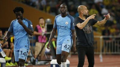 Manchester City manager Pep Guardiola, right, as Wilfried Bony, left, and Yaya Toure are substituted during their friendly against Borussia Dortmund in China. Reuters / Bobby Yip