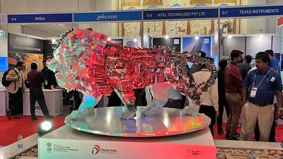 Visitors stand next to a 'Make In India' logo during a three-day semiconductor event in Bengaluru in April 2022. Reuters