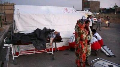 A woman lies injured on a stretcher after an earthquake in the city of Varzaqan in northwestern Iran.
