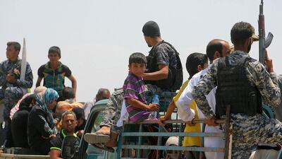 Families from Fallujah flee their homes during fighting between Iraqi security forces and ISIL. Anmar Khalil / AP