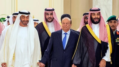 Sheikh Mohamed bin Zayed walks with Mr Hadi and Prince Mohammed bin Salman at the ceremony. AFP