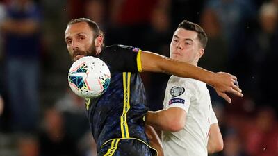Kosovo's Vedat Muriqi in action with England's Michael Keane. Reuters