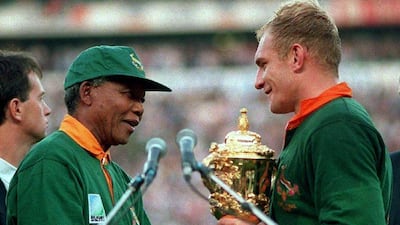 South African President Nelson Mandela, right, hands over the William Webb Ellis Cup to Springbok captain Francois Pienaar after the 1995 Rugby World Cup final victory over New Zealand. Reuters