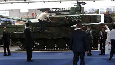 Above, visitors at the Rhein Mettall stand. Satish Kumar / The National