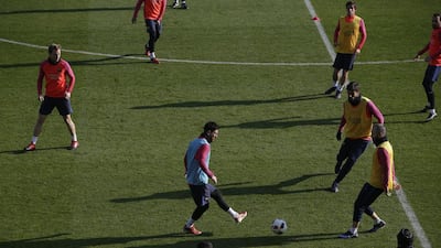 Lionel Messi, centre, kicks the ball during a training session. Manu Fernandez / AP