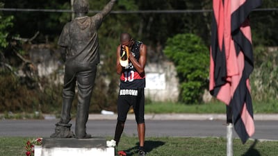 A Flamengo's soccer fan reacts in front of the club's training center, after a deadly fire, in Rio de Janeiro, Brazil. REUTERS