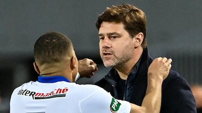 Paris Saint-Germain's Kylian Mbappe celebrates with head coach Mauricio Pochettino. AFP