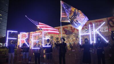 Demonstrators hold neon lit 'FREE HK' lights during a rally marking the 30th anniversary of the Eastern Europe Revolutions at Edinburgh Place in the Central district of Hong Kong, China, on Sunday, November 17, 2019. Dylan Hollingsworth/Bloomberg