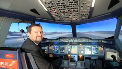 Wolfram Schleuter, chief executive of iPilot, on the flight simulator at Yas Mall in Abu Dhabi. Ravindranath K / The National