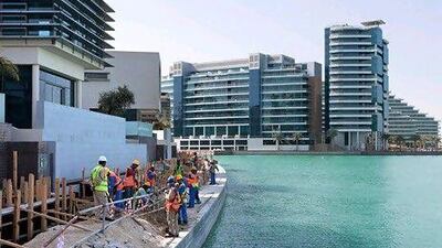 Rents in Abu Dhabi will continue to fall as supply outpaces demand. Above, construction work at the Al Raha beach development. Duncan Chard / Bloomberg News