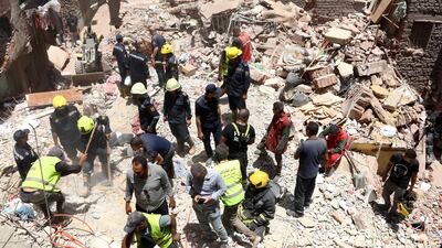 Rescuers search the rubble of the collapsed five-storey apartment building in Cairo. AP