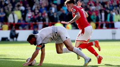 James Milner of Liverpool battles for possession with Neco Williams of Nottingham Forest. Getty