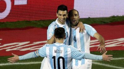 Argentina's Lionel Messi celebrates with Javier Pastore, left, and Pablo Zabaleta, after Pastore's goal against Paraguay in their side's 6-1 Copa America semi-final victory over Paraguay. Jorge Adorno / Reuters / June 30, 2015