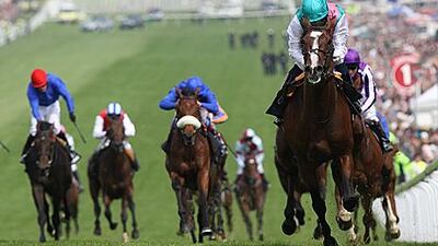 Ryan Moore and Workforce, right, lead the field on the way to winning on Derby Day at Epsom last year.