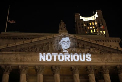 An image of US Supreme Court Justice Ruth Bader Ginsburg is projected onto the New York State Civil Supreme Court building in Manhattan after she passed away on September 18, 2020. Reuters