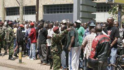Security officers keep a crowd under control outside the Westgate mall. A witness said that gunmen told Muslims to stand up and leave and that non-Muslims would be targeted. Initial police reports had described the incident as a botched robbery. Jason Straziuso / AP Photo