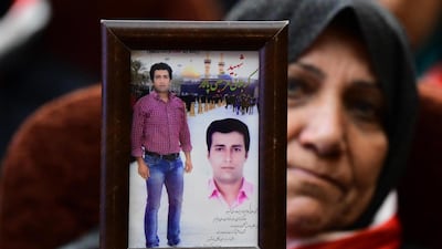 An Iraqi woman carries a picture of an Iranian revolutionary guards member who was killed during the fighting against ISIS during a ceremony honoring of the Iran revolutionary guards fighters in Baghdad, Iraq. EPA