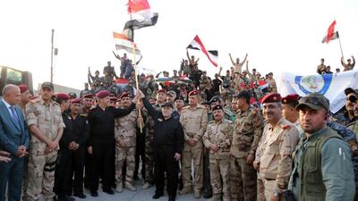 Iraqi prime minister Haider Al Abadi, centre, declares Mosul's liberation from ISIL in the northern Iraqi city on July 10, 2017, after nine months of fierce fighting by Iraqi forces and a US-led coalition to oust the militants from their final stronghold in the country. Iraq Prime Minister's Office / EPA